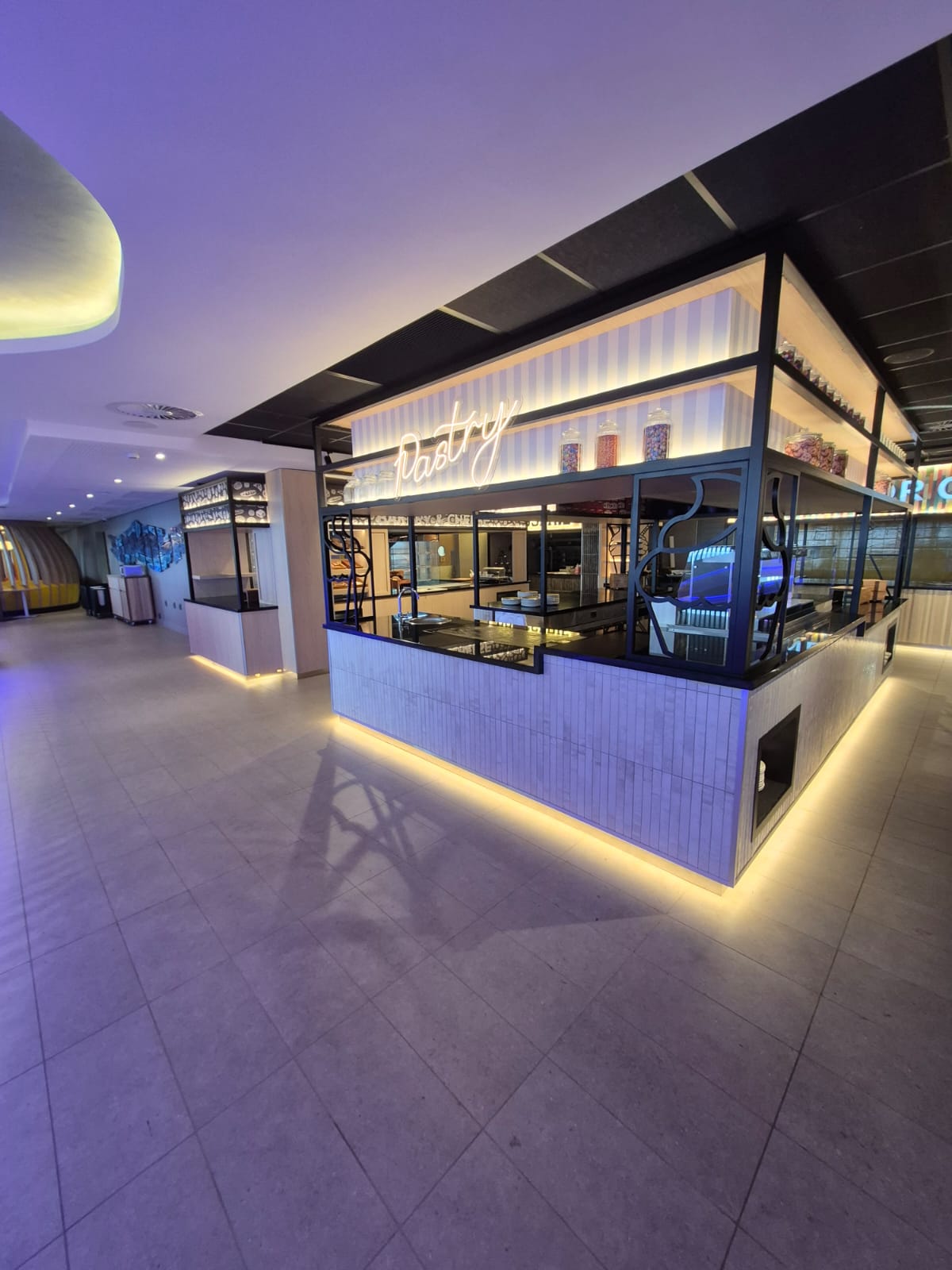 Wide view of the Pastry island counter with cove lighting to the plinth
