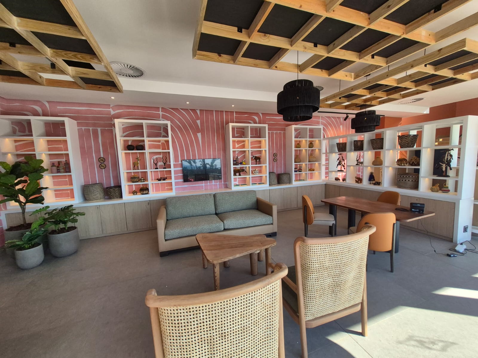 Full view of the lounge joinery run — low cabinets below, lit display boxes above